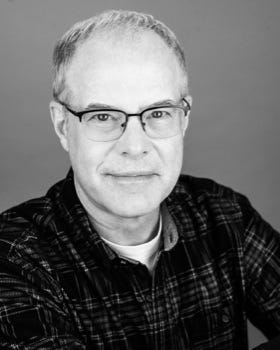 A person wearing glasses and a plaid shirt

AI-generated content may be incorrect.