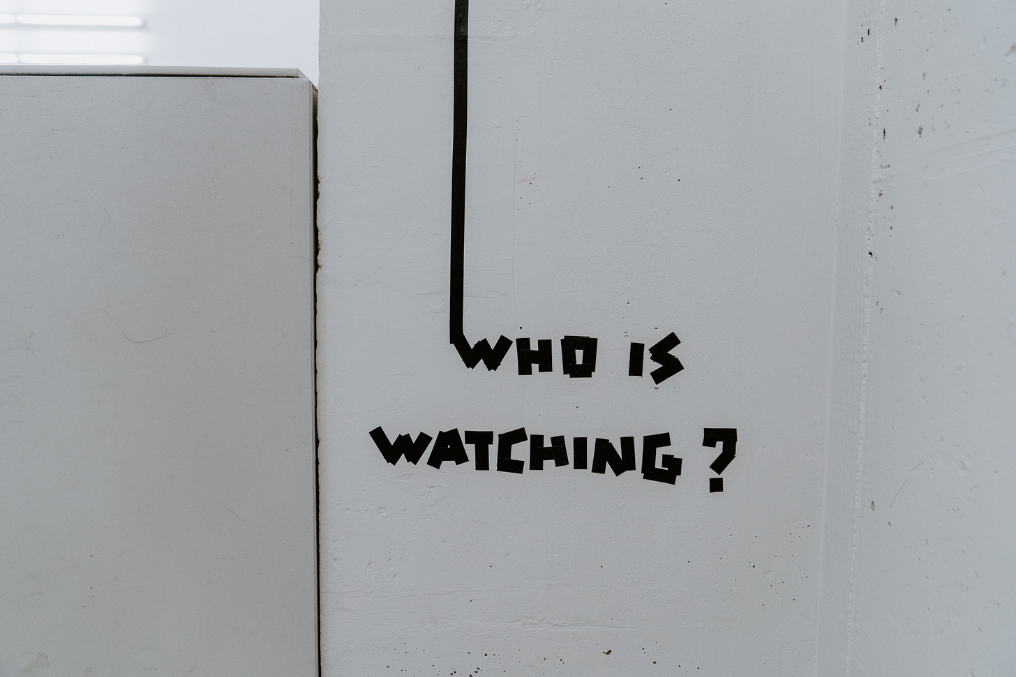 A picture of Who is Watching? painted on a wall A picture of Who is Watching? painted on a wall