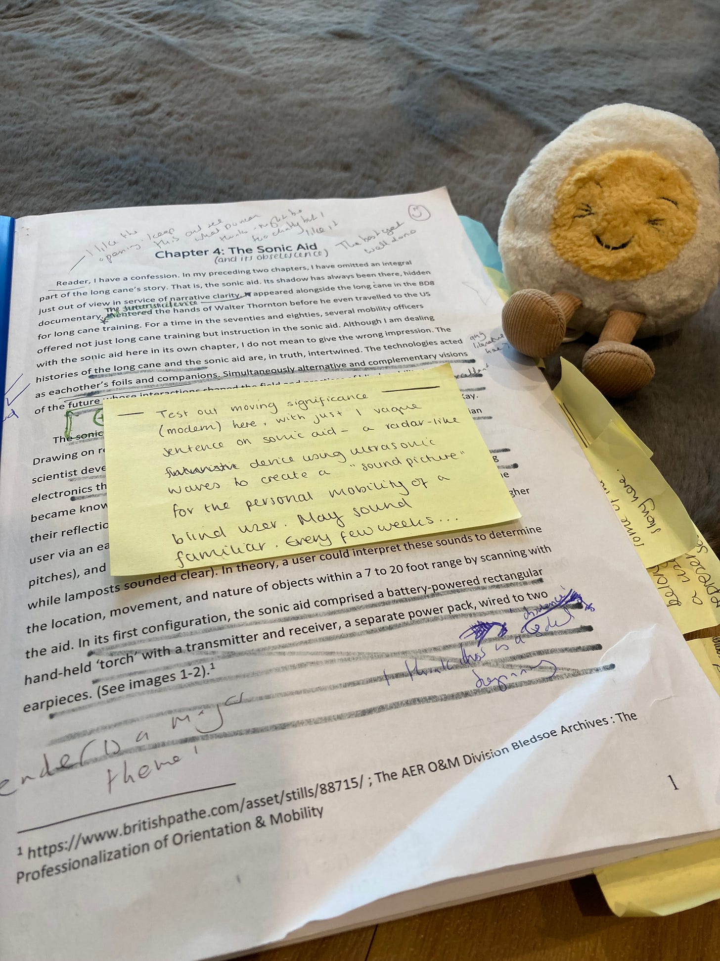 Printed chapter covered in yellow stickynotes, arrows, notes in different handwriting and pens in the margins. One of the notes is from Neil saying: 'the best [chapter] yet, Well done!' Another scribbled note says 'gender is a major theme!'