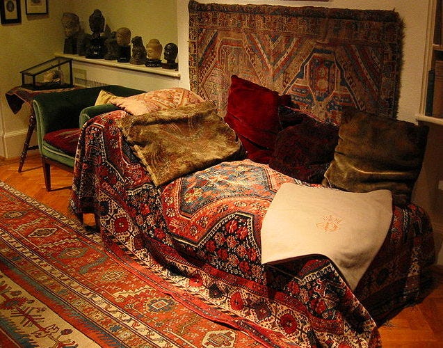 A couch with pillows and a rug

Description automatically generated