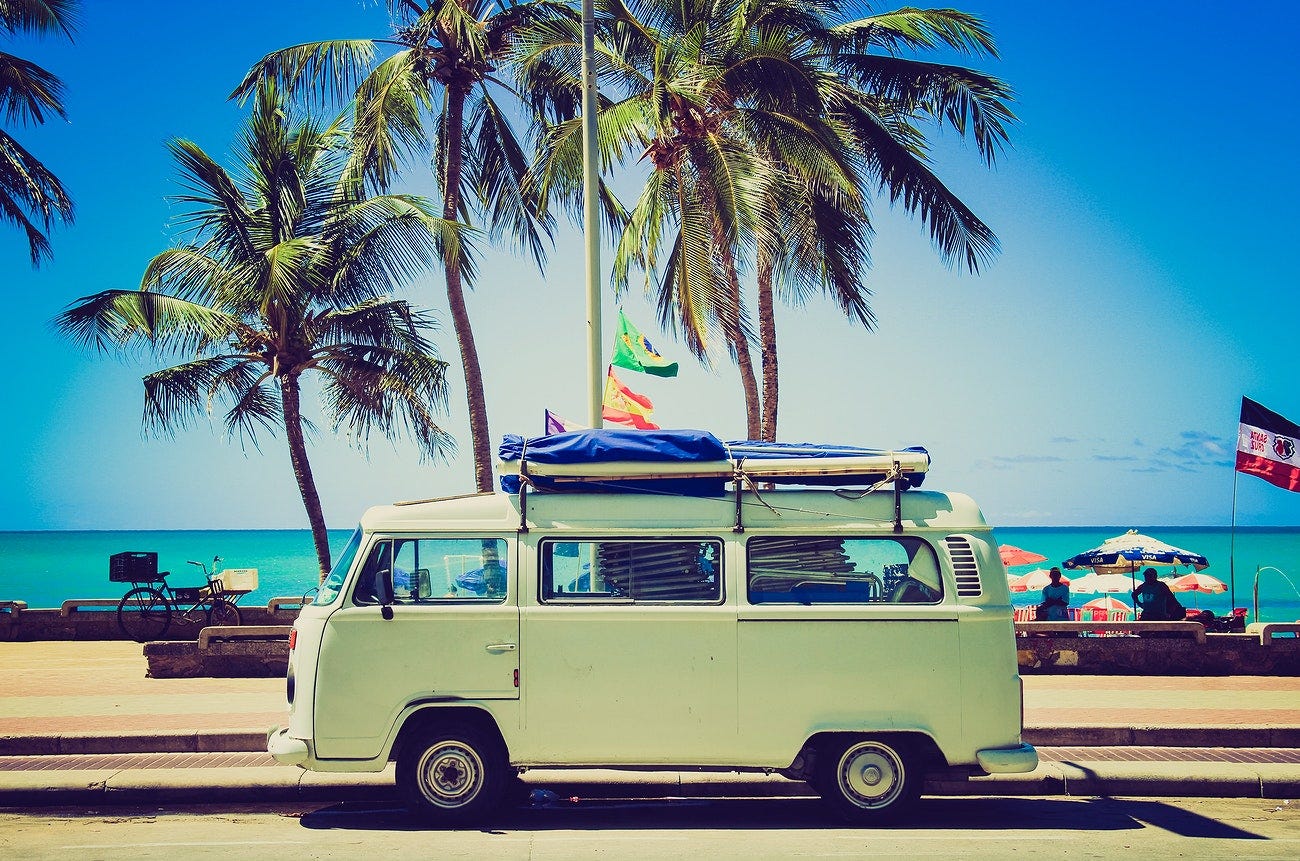 Light green Volkswagen Van at the side of the beach