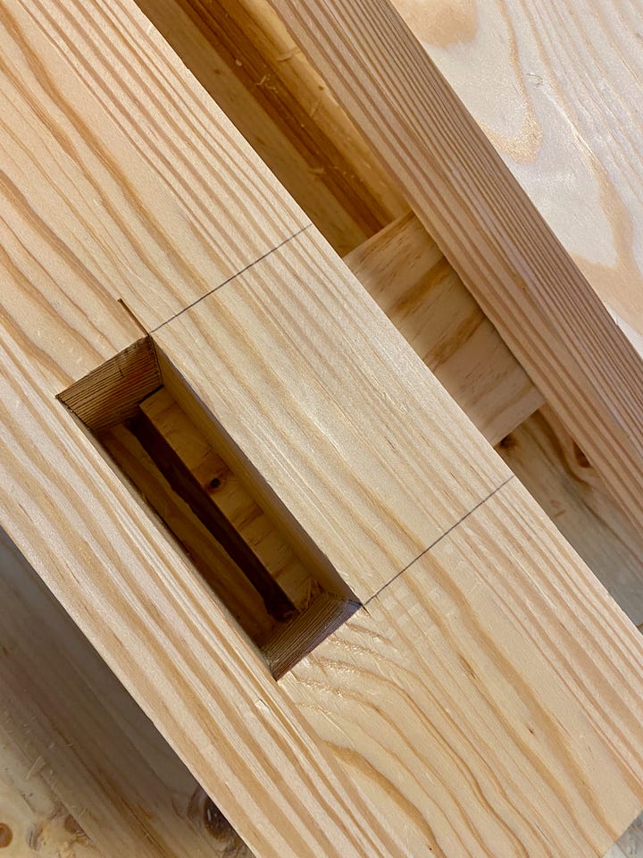 The first photo shows the base of the bench dry fit. The second photo shows one tenon insert into the stretcher.