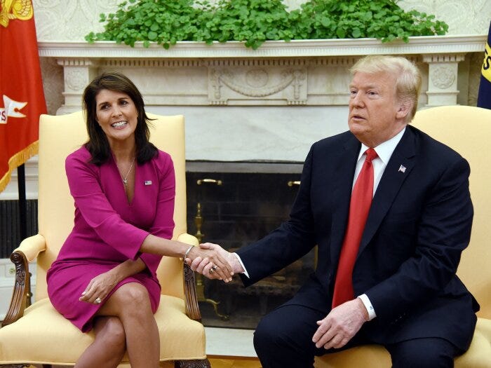 Then-President Donald Trump shakes hands with Nikki Haley, then the United States Ambassador to the United Nations in the Oval office of the White House on October 9, 2018 in Washington, DC.