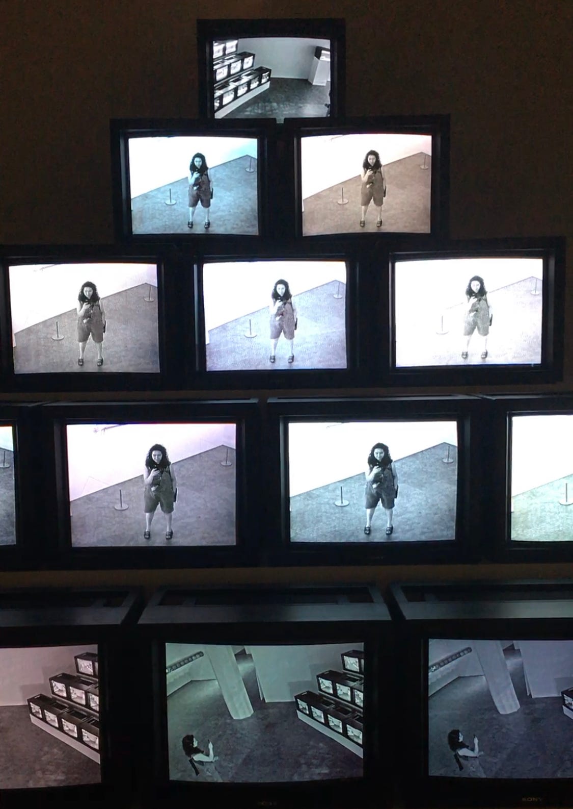 From the exhibit I went to at ZKM on surveillance, the day before going to the archives—a stack of CCTVs showing my recent movements, and me taking a video.