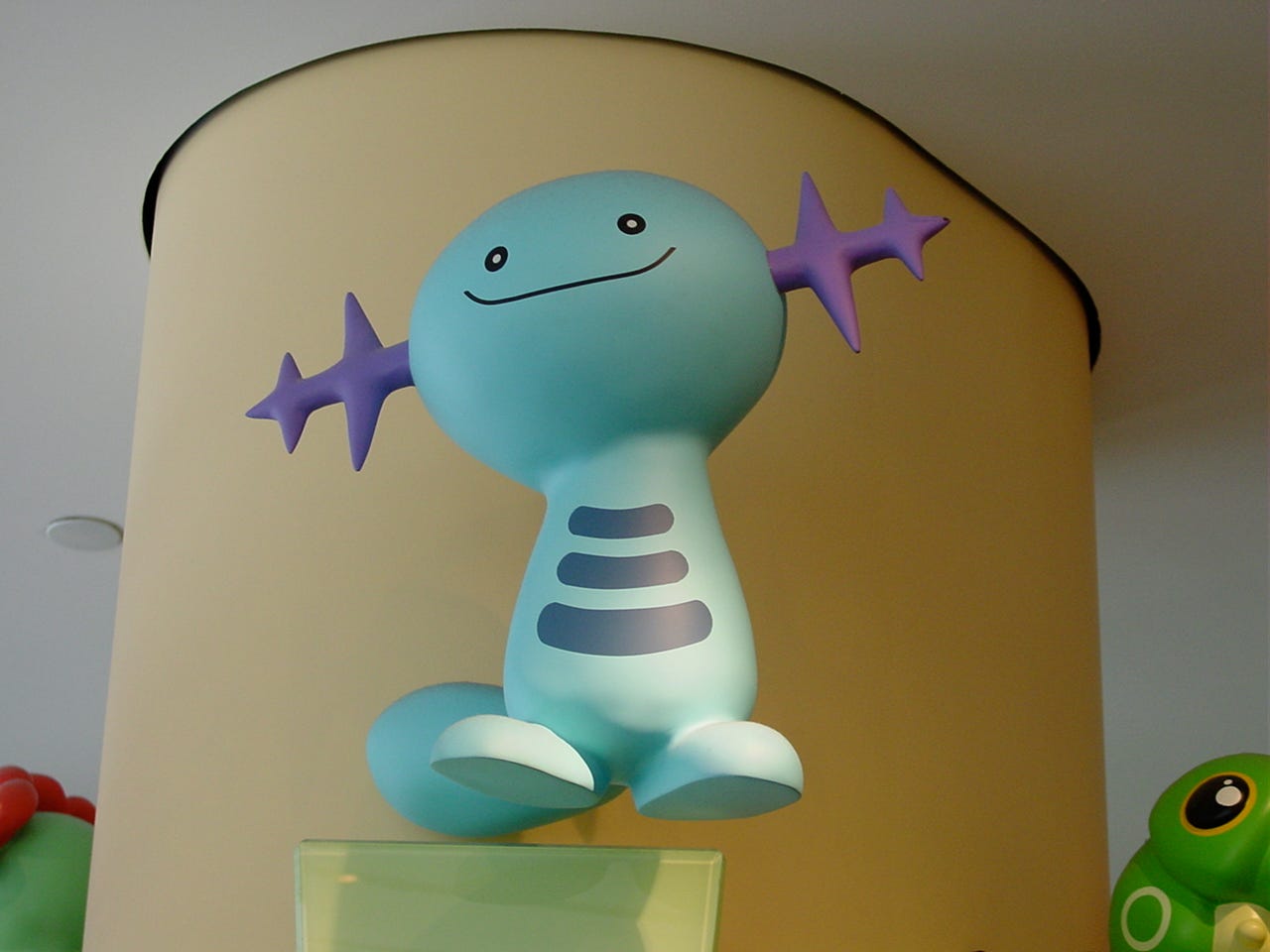A close-up shot of Wooper’s statue from the ground floor. The store’s Caterpie statue is also slightly captured in this shot A close-up shot of Wooper’s statue from the ground floor. The store’s Caterpie statue is also slightly captured in this shot