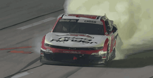 a red and white race car with the word creed on the windshield