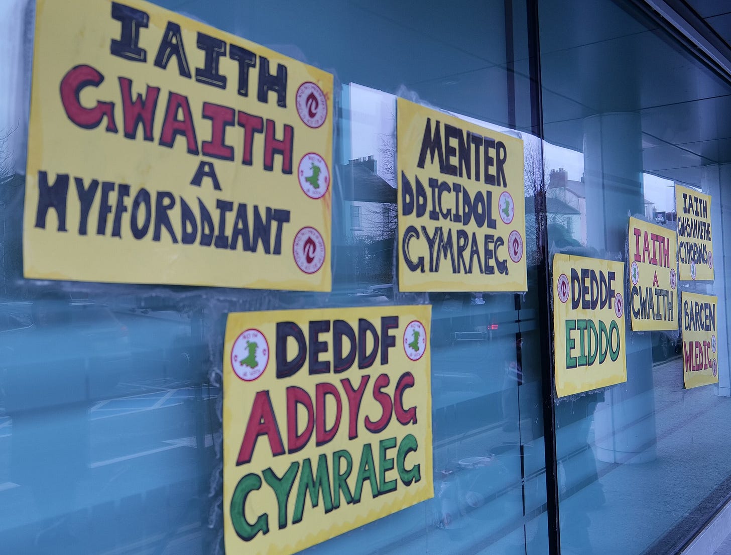 Handwritten signs in Welsh in a window Handwritten signs in Welsh in a window