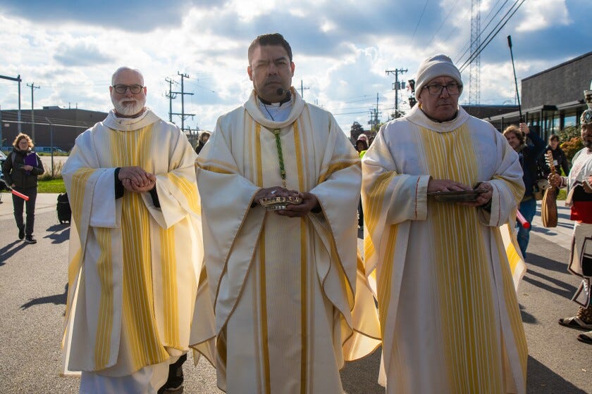 Priests walk to ask permission to give communion to detainees Saturday outside the U.S. Immigration and Customs Enforcement facility in Broadview.  Priests walk to ask permission to give communion to detainees Saturday outside the U.S. Immigration and Customs Enforcement facility in Broadview.