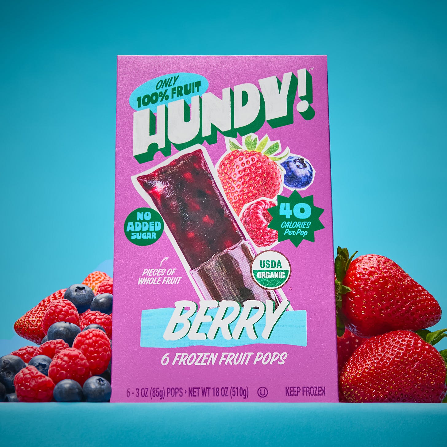 a box of Hundy berry flavored pops on a blue background and surrounded by fresh berries a box of Hundy berry flavored pops on a blue background and surrounded by fresh berries