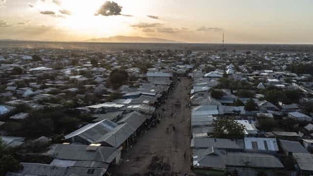 A settlement of tin-roofed houses at sunset. A settlement of tin-roofed houses at sunset.