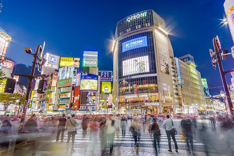 A group of people crossing a street

Description automatically generated
