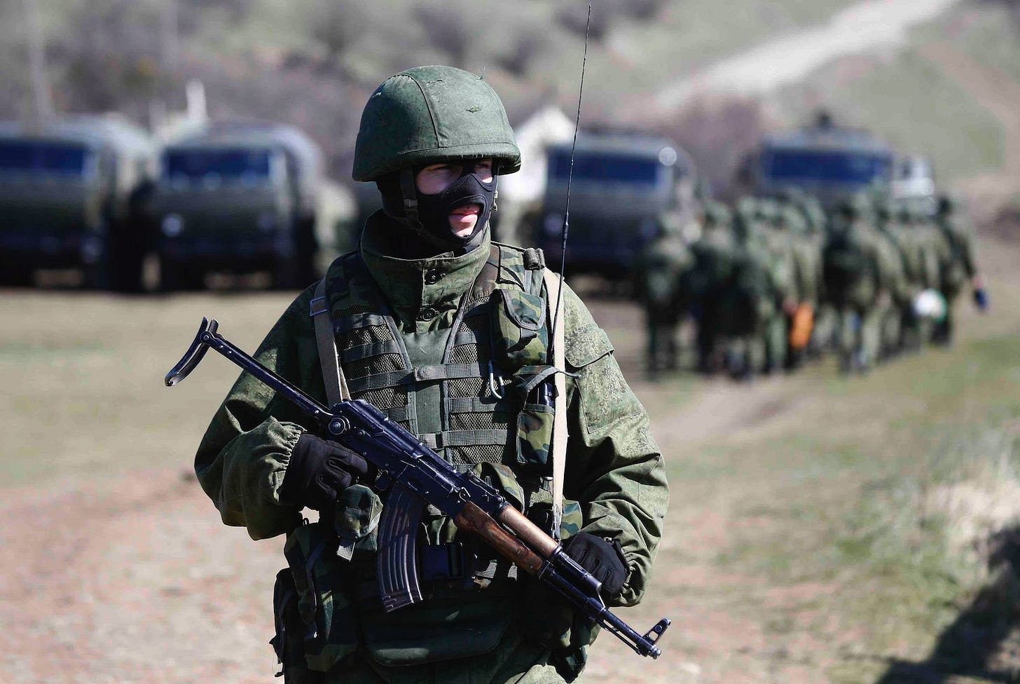 An armed man, believed to be a Russian soldier, stands on guard outside a military base in Perevalnoye, near the Crimean city of Simferopol in March 2014