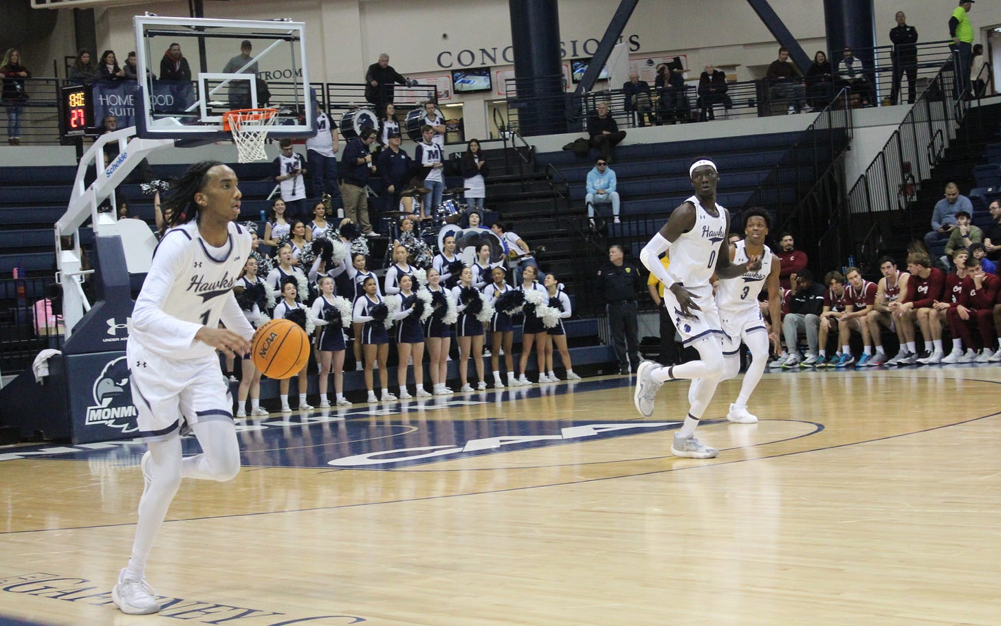 Abdi Bashir Jr. (1) brings the ball up the court with Dok Muordar (0) and Madison Durr (3) close behind during Monmouth’s win over Charleston on Jan. 11, 2025. (Photo by Adam Zielonka) Abdi Bashir Jr. (1) brings the ball up the court with Dok Muordar (0) and Madison Durr (3) close behind during Monmouth’s win over Charleston on Jan. 11, 2025. (Photo by Adam Zielonka)