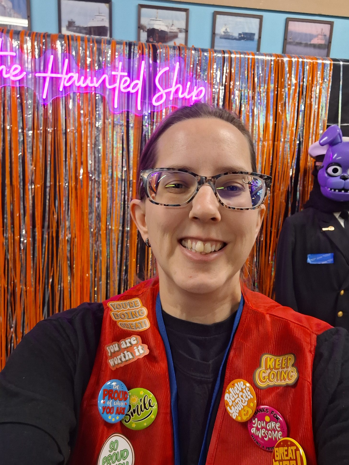 woman smiling at a haunted house