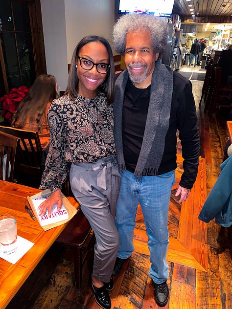 Tirrea Billings smiles alongside a man with gray curly hair in a cozy restaurant, resting her hand on a table with a book titled Soulitary nearby. In the second image, a wide shot shows Tirrea and another speaker onstage at the Making and Unmaking Mass Incarceration (MUMI) conference in front of a projected slide that reads “Collective Power, Community Change – Mississippi,” as attendees sit in white folding chairs. The third image shows Tirrea posing in front of the official MUMI conference backdrop, wearing a name badge, floral blouse, and burnt orange cardigan, smiling confidently at the camera.