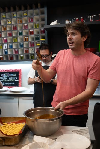 Chef Ignacio Barrios is showing how thick the syrup should be for the dessert.