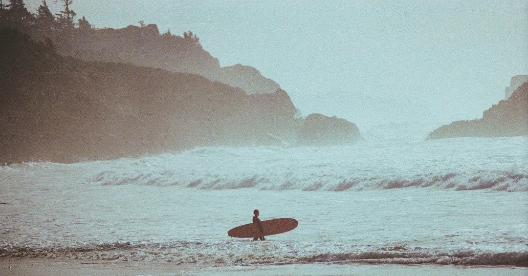 a person with a surfboard in the water