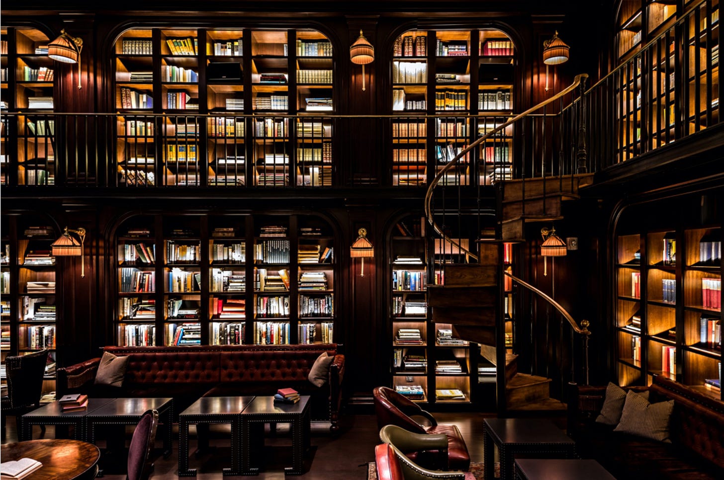 Library room with dimmed lighting and spiral staircase