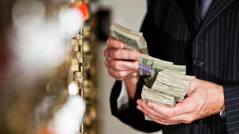 Hands holding stacks of money