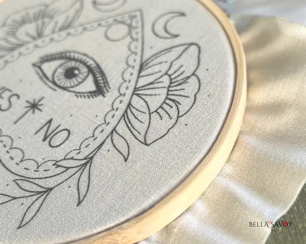 planchette embroidery design on hooped fabric