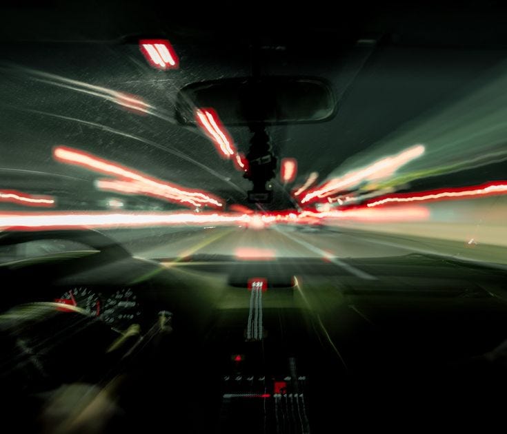This may contain: a car driving down a street at night with motion blurs on the cars windshield This may contain: a car driving down a street at night with motion blurs on the cars windshield