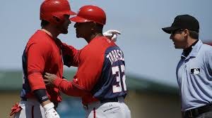 Bryce Harper arguing with the umpire as Tony Tarasco tries to hold him back