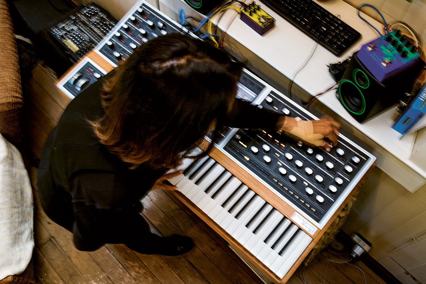 An overhead shot of Suzanne Ciani manipulating a Moog keyboard.