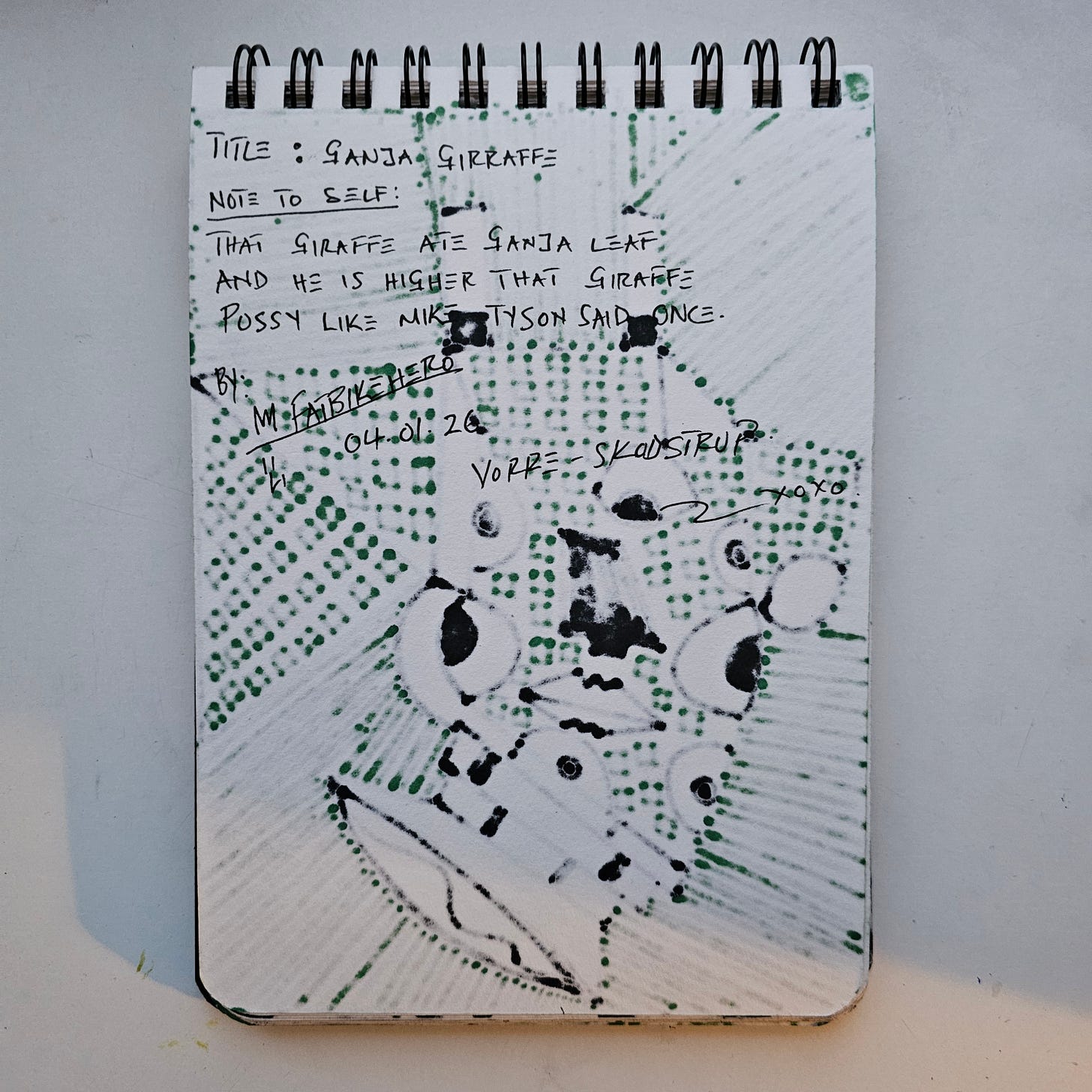 Handwritten conceptual art notes by International artist FatbikeHero (b. 1983) titled 'Ganja Girraffe,' dated January 4, 2026, featuring a humorous Mike Tyson reference. Handwritten conceptual art notes by International artist FatbikeHero (b. 1983) titled 'Ganja Girraffe,' dated January 4, 2026, featuring a humorous Mike Tyson reference.