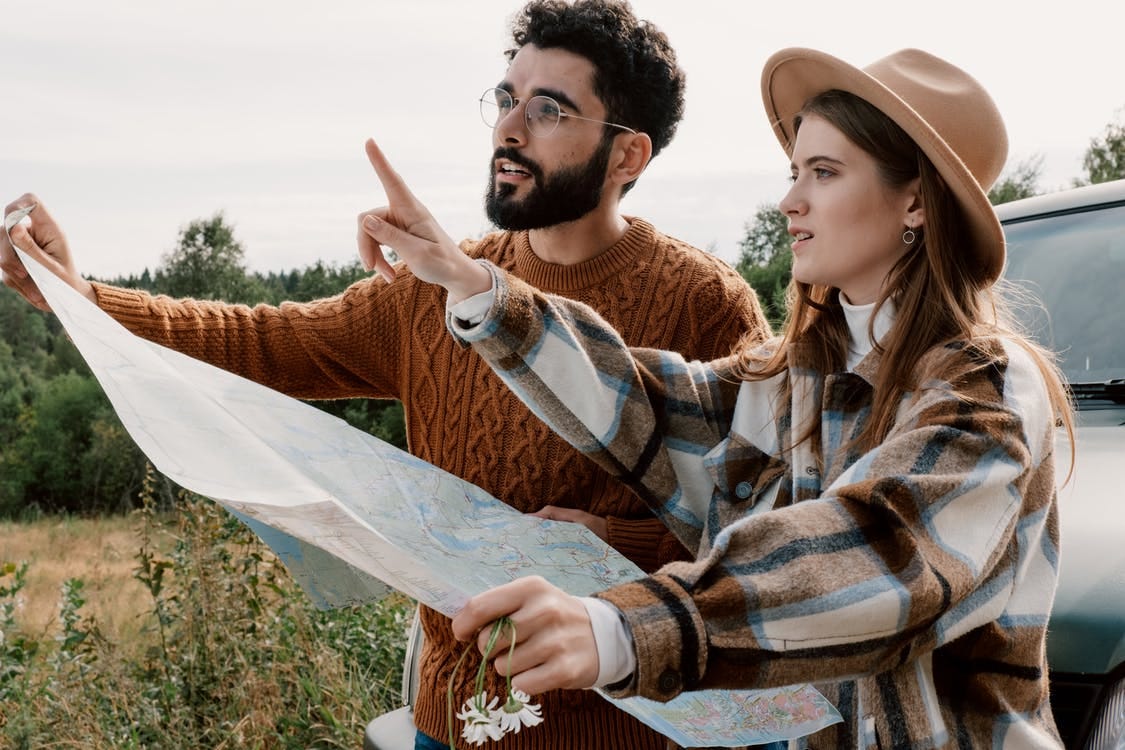 Man in Brown and White Plaid Dress Shirt Holding White Textile