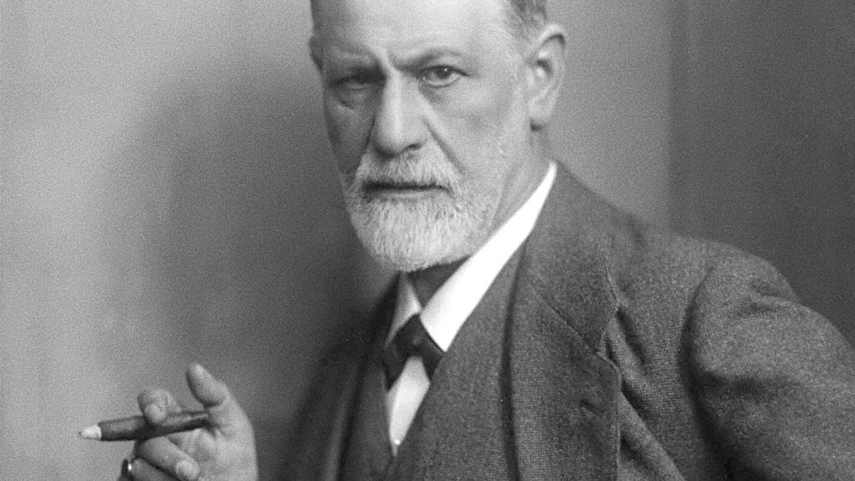 Post cover art A black and white photograph of Sigmund Freud looking intensely into the camera while holding a cigar on his right hand.