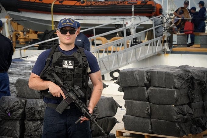 A US Coast Guardsman guards $61.6 million dollars worth of seized cartel cocaine as it is offloaded in Florida, on Thursday, May 14, 2026