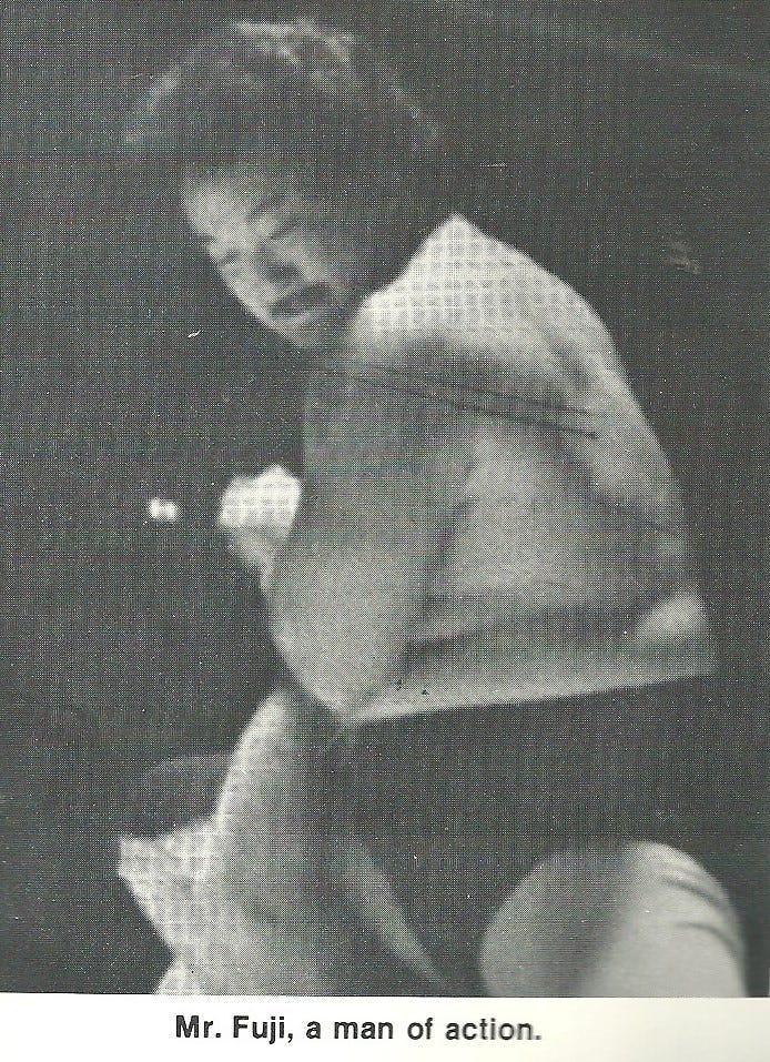 May be a black-and-white image of text that says 'Mr. Fuji, a man of action.' May be a black-and-white image of text that says 'Mr. Fuji, a man of action.'