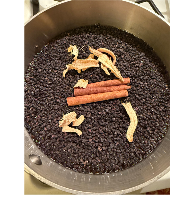 A bowl of food with cinnamon sticks and dried herbs

AI-generated content may be incorrect.