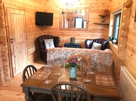 inside the cabin showing kitchen diner area, living room and bedroom
