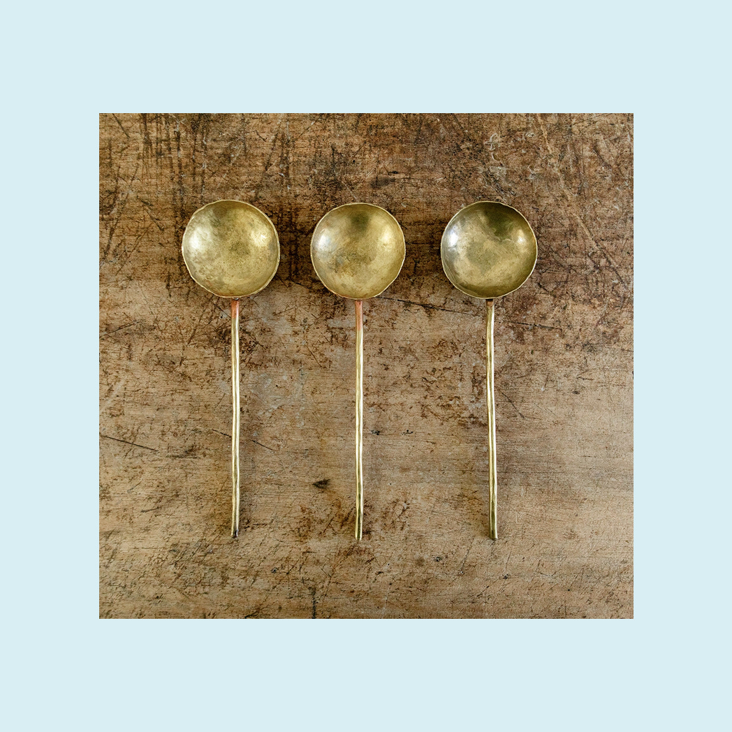 A set of fancy brass serving spoons