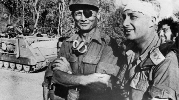 A file picture taken in October 1973 and provided by the Israeli Army shows Ariel Sharon with Moshe Dayan on the western side of the Suez Canal during the Yom Kippor war. [AFP]