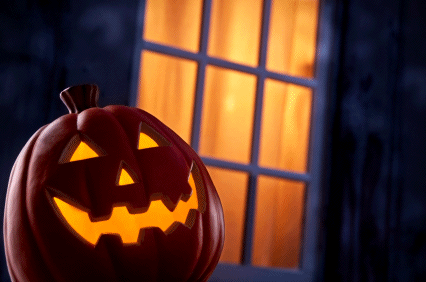 gif of glowing jack o lantern in front of window