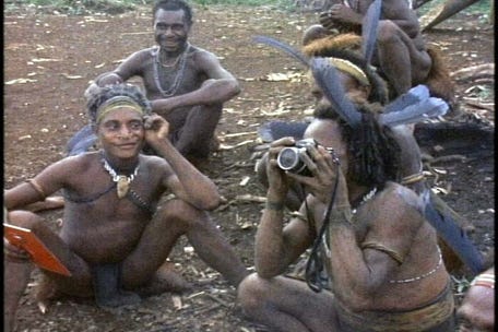 A group of men sitting on the ground

AI-generated content may be incorrect.