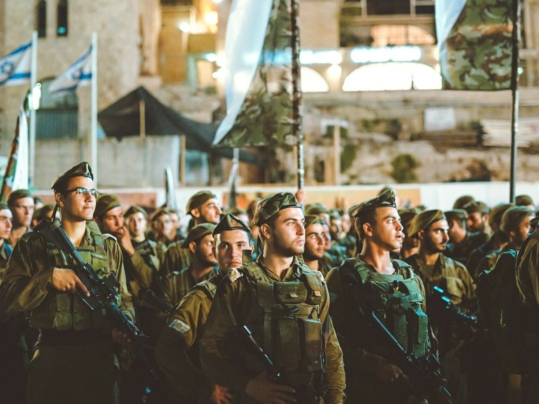 group of armed men with white flag
