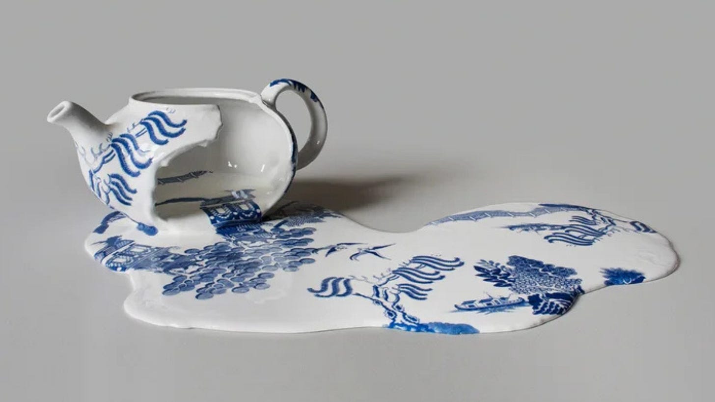 Through a large break in the side of a teapot, a puddle of porcelain pours out. Elements of the chinoiserie "Willow Pattern" also appear to slide out of the break and across the surface of the porcelain puddle.