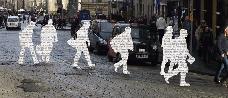 This may contain: people are walking down the street with cut out figures