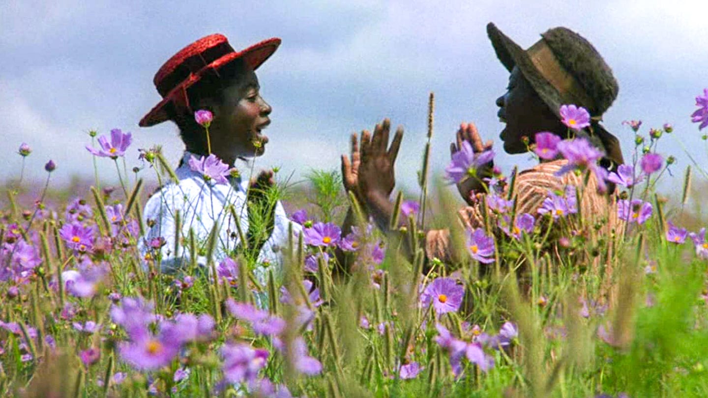 Two young Black women laugh and clap hands in a field of purple flowers, sunlight filtering through. A joyful reunion set against a blooming landscape. Two young Black women laugh and clap hands in a field of purple flowers, sunlight filtering through. A joyful reunion set against a blooming landscape.