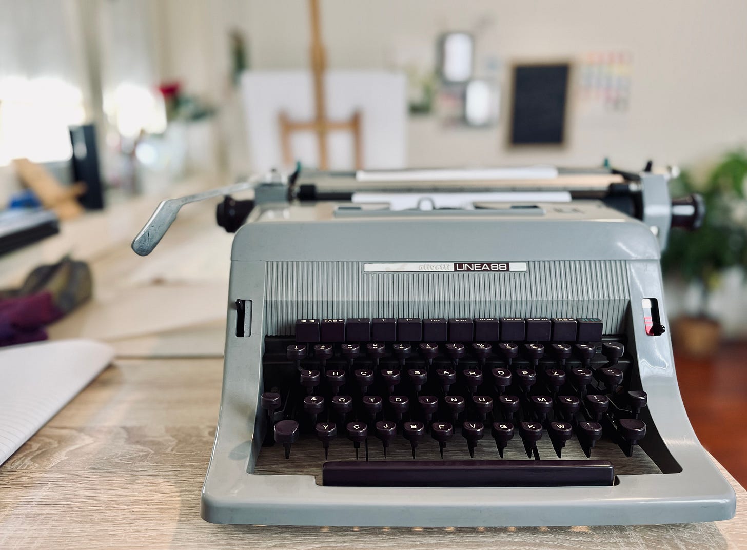 mage: photo gallery of a vintage Olivetti Linhea 88 typewriter on a studio table 