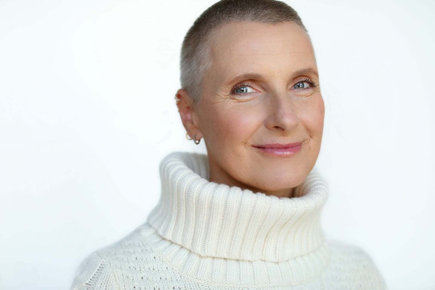 Photo of Elizabeth Gilbert. Her hair is buzzed and she is wearing a chunky white turtleneck sweater. Photo of Elizabeth Gilbert. Her hair is buzzed and she is wearing a chunky white turtleneck sweater.