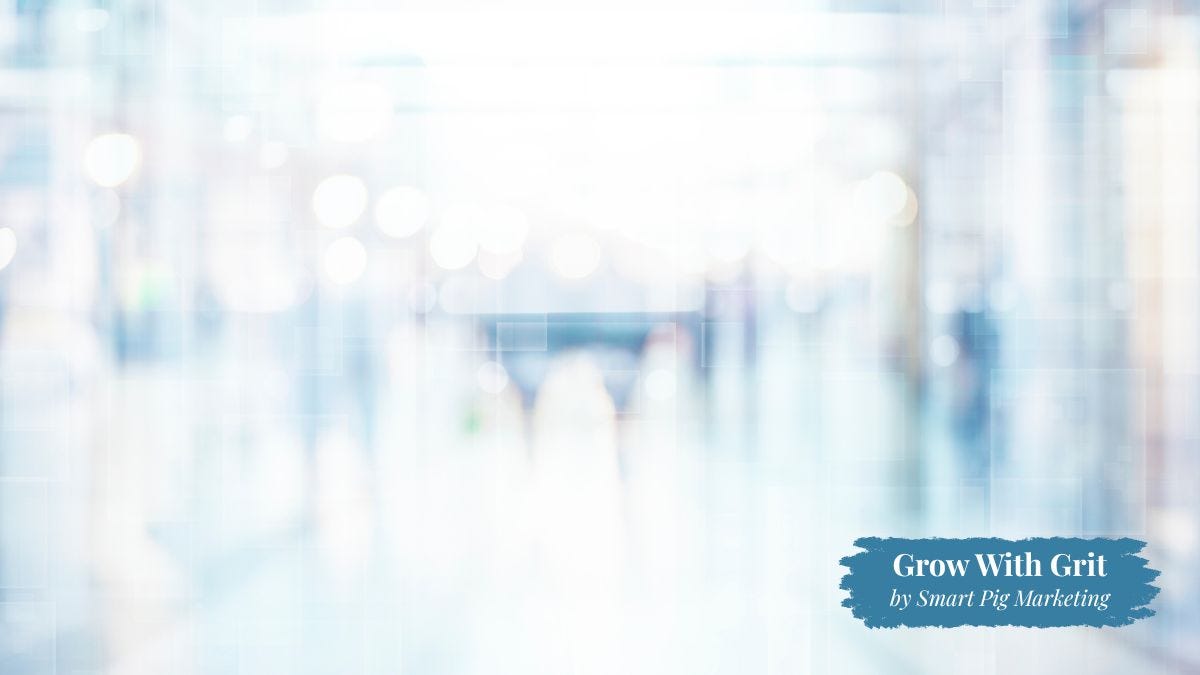 A softly blurred view of a bright indoor public space with no clear focal point, symbolizing how businesses can become forgettable when they fail to differentiate themselves. The image represents the importance of creating a clear, memorable customer experience. Grow With Grit by Smart Pig Marketing branding appears in the lower right corner.