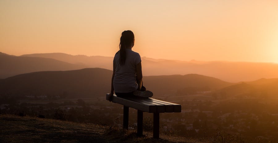 Lady watching sunset and thinking