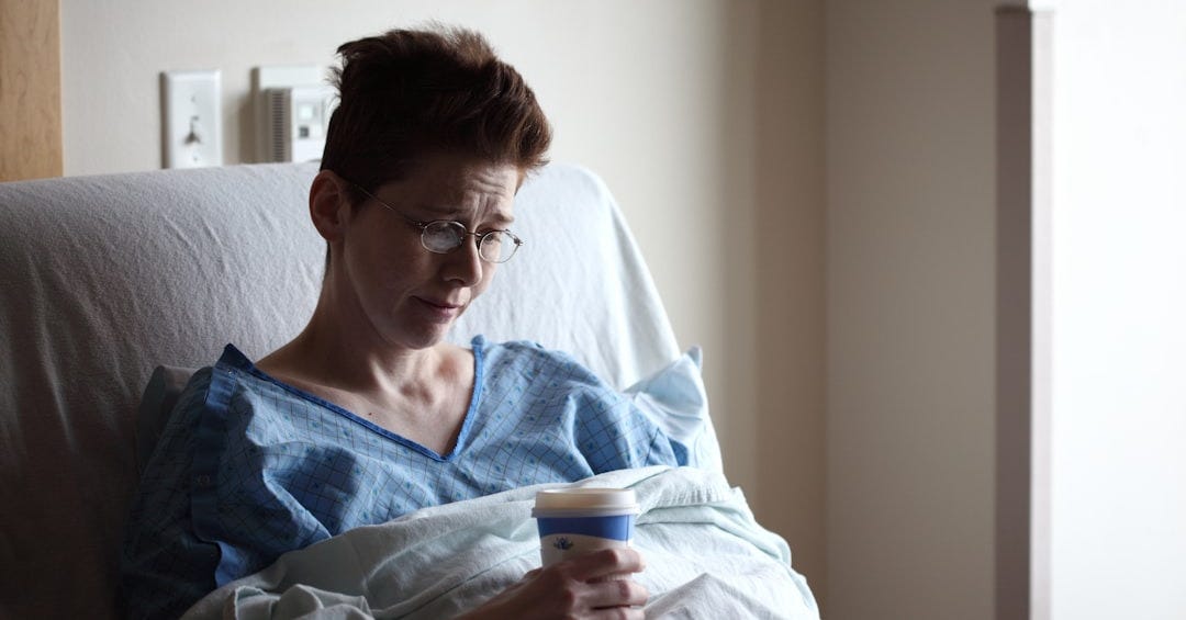 woman on bed holding plastic cup woman on bed holding plastic cup