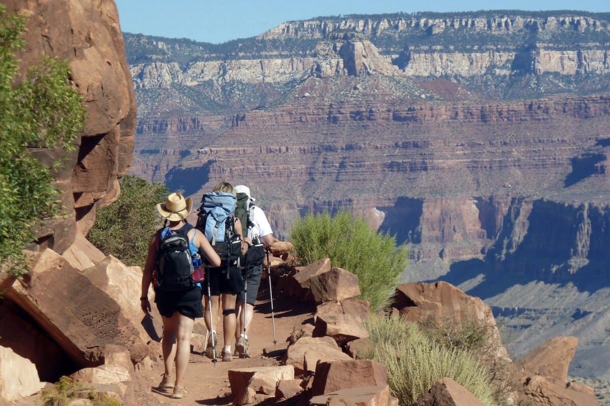 Hikers traverse the breathtaking South Kaibab Trail within Grand Canyon National Park, Arizona, in this evocative photo from September 27, 2010, showcasing the enduring beauty of American natural landscapes.