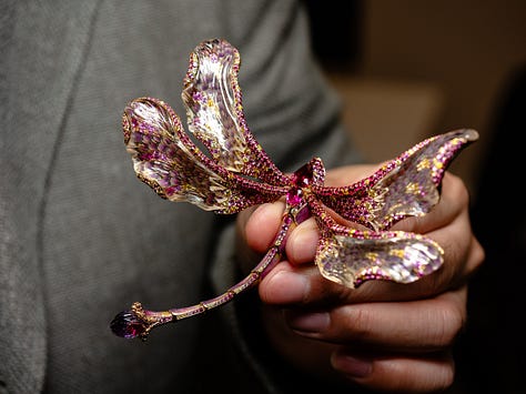 An antique opal and diamond watch in the Flames of Opal Essence exhibition, a ring by Sharvash Hakobian, a dragonfly brooch by Chong Ho, a brooch at Strong & Precious, a necklace by Jaqueline Powers, a ring by William Llewellyn Griffiths, all on show at GemGenève.