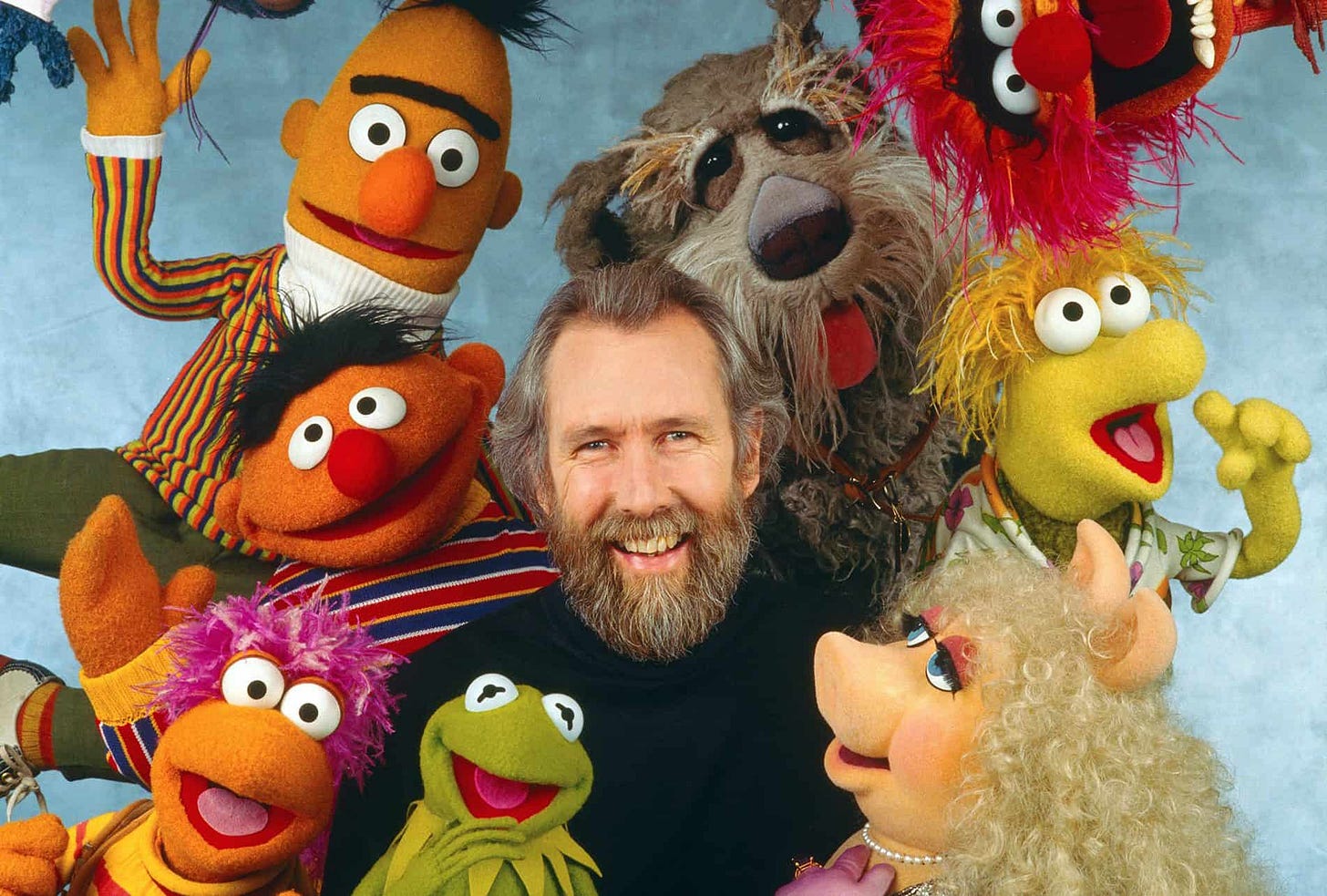 https://cdn.shortpixel.ai/spai/q_lossy+ret_img+to_auto/www.killyourdarlings.com.au/wp-content/uploads/2019/06/Jim_Henson_surrounded_by_Muppets_Fraggles_Sesame-e1560474554434.jpg